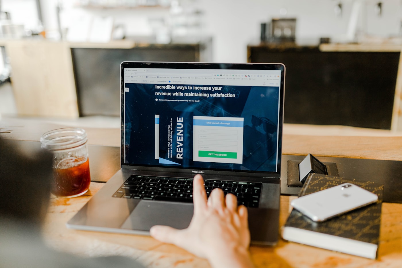 A modern small-business website shown on a laptop on a dark desk
